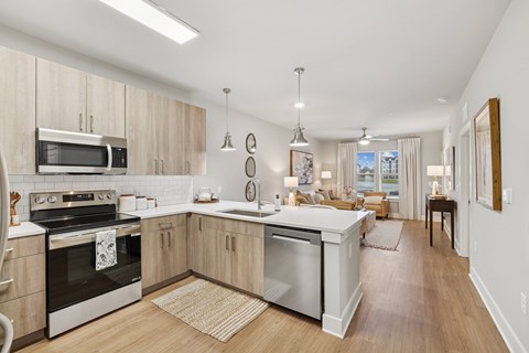 A modern kitchen with wooden cabinets and stainless steel appliances.
