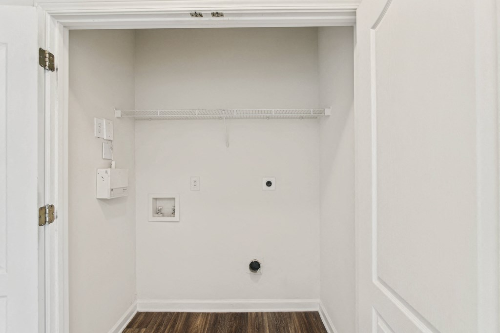 an empty room with a white wall and a white door