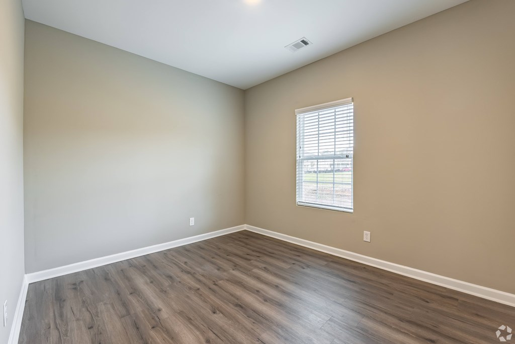 A room with wooden flooring and a window with blinds at Club Villas Apartments, Kathleen