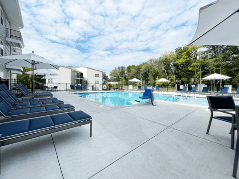 A pool area with sun loungers at Emery Village, Concord, NC