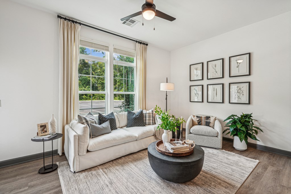 a living room with a couch and a chair and a ceiling fan at The Leo Myrtle Beach, Myrtle Beach, SC
