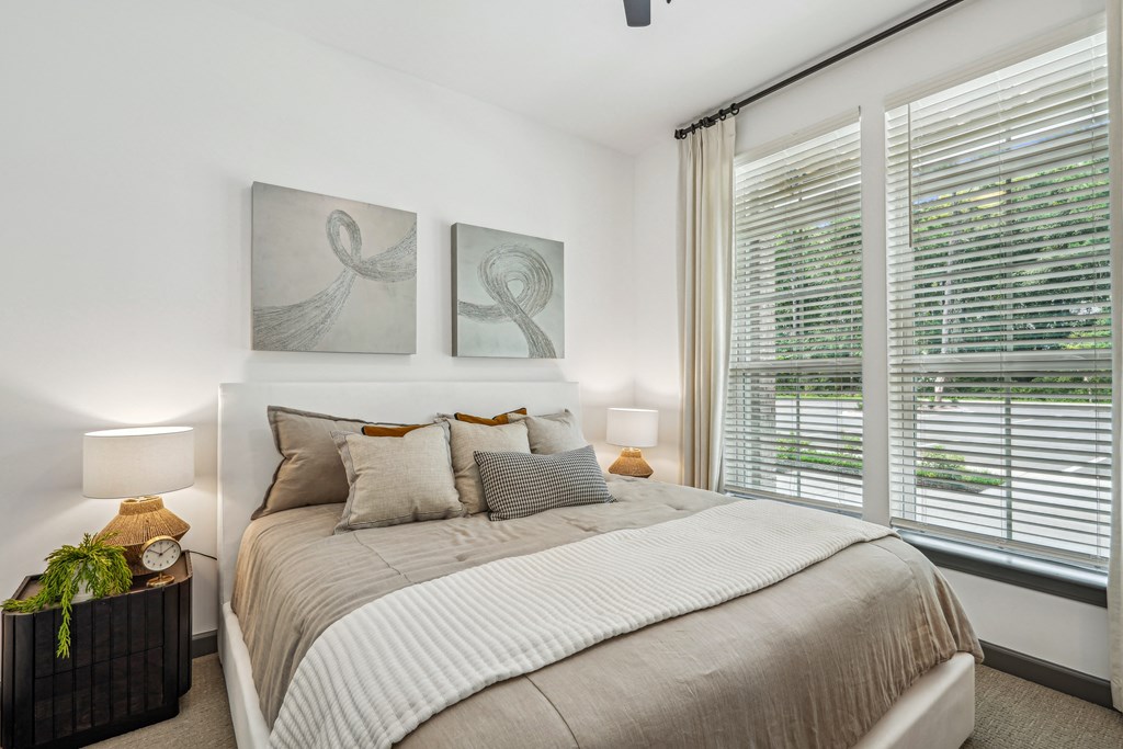 a bedroom with a bed and two paintings on the wall at The Leo Myrtle Beach, Myrtle Beach, SC, 29579