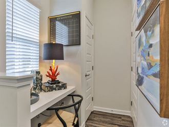 a room with a desk and a lamp and a door