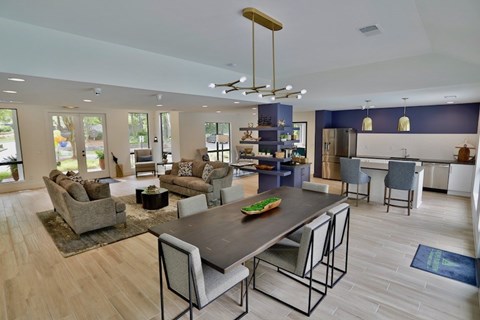 A modern dining room with a large table and chairs.