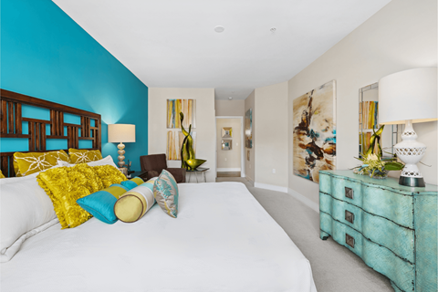 Bedroom with large bed and night lamp at Hidden Creek, Gaithersburg