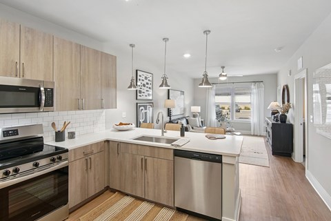 A modern kitchen with wooden cabinets and stainless steel appliances.