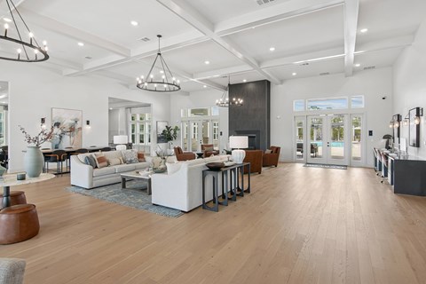 A spacious living room with a variety of furniture and decor.