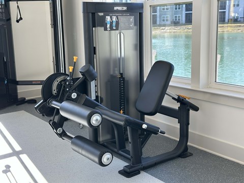 A black and silver gym machine is in front of a window at The Beacon at 331 Apartments, Santa Rosa Beach, FL
