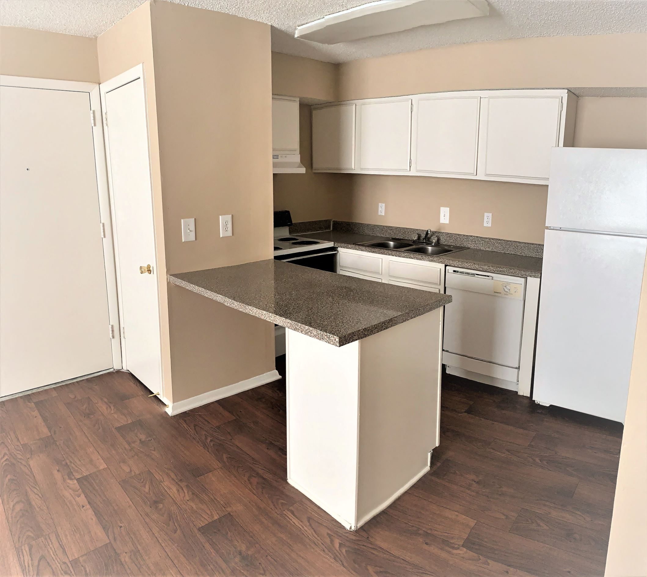 an empty kitchen with an island in the middle of it