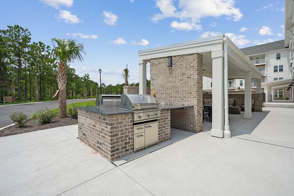Outdoor kitchen with a grill and a pavilion at The Leo Myrtle Beach, South Carolina, 29579