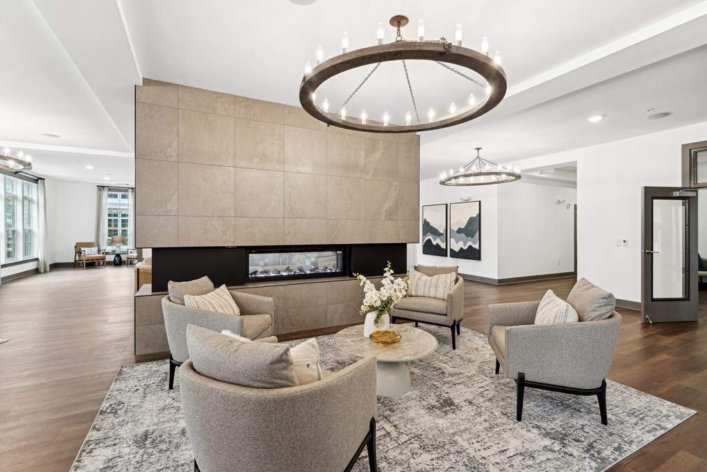 a living room with couches and chairs and a fireplace at The Leo Myrtle Beach, Myrtle Beach, 29579
