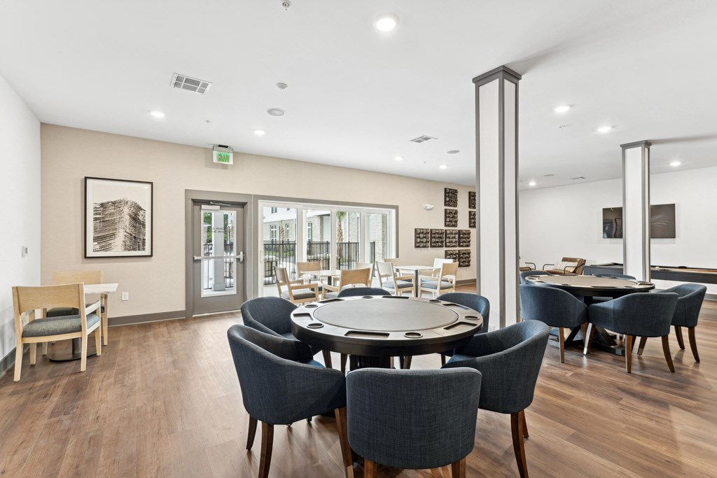 a dining room with a round table and chairs at The Leo Myrtle Beach, South Carolina