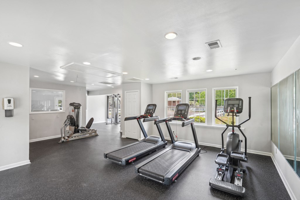 A spacious gym with treadmills and elliptical machines at Lexington on the Green, North Carolina