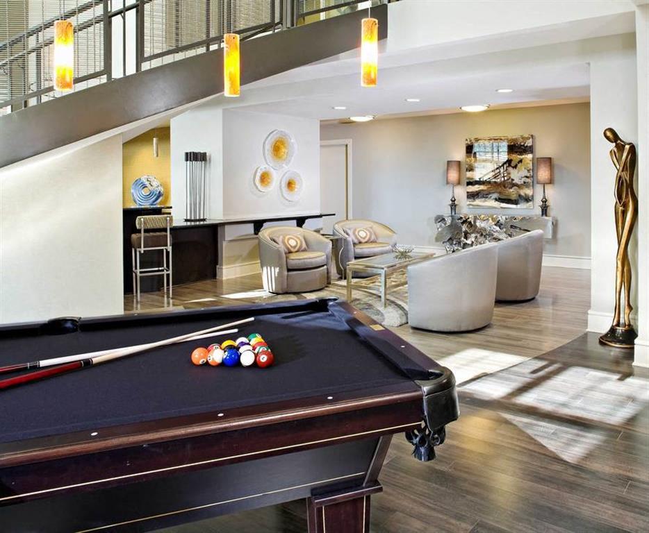 a living room with a pool table and a bar