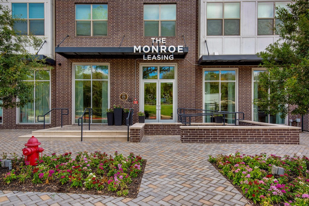 the front of the leasing building with a red fire hydrant at The Monroe Apartments, Austin, 78741