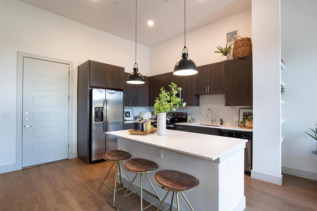Kitchen with a large island at The Monroe Apartments, Texas, 78741