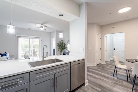 A modern kitchen with a large island and a dining table.