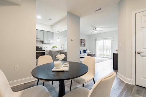A dining room with a table set for two.