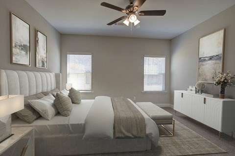 A bedroom with a large bed and a ceiling fan.