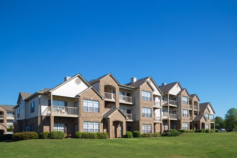 A large apartment complex with multiple balconies and windows.