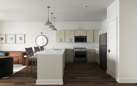A modern kitchen with a brown wooden floor and white walls at The SoHo Luxury Apartments, Raleigh