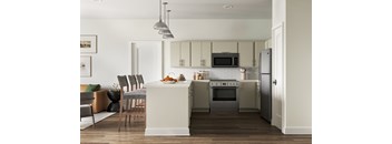 A modern kitchen with a dining table and chairs at The SoHo Luxury Apartments, Raleigh, 27603