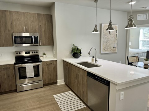 A modern kitchen with a stainless steel oven and a white countertop.
