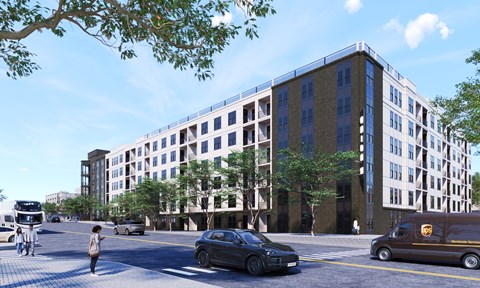 A street view with a building, cars, and a person.