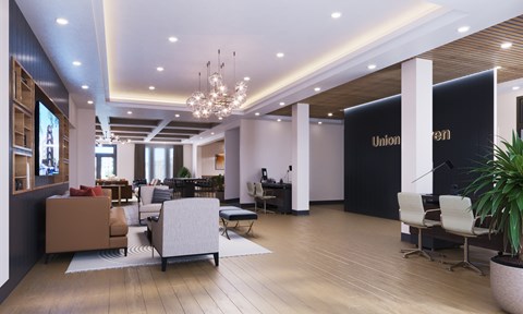 A modern office lobby with a reception desk and a large plant.