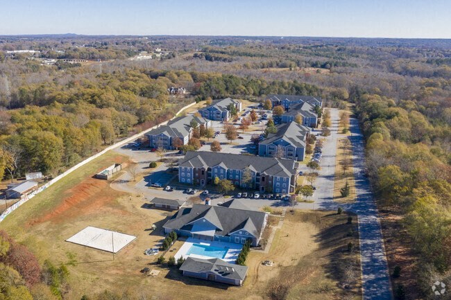 an aerial view of a neighborhood with houses and trees in the background