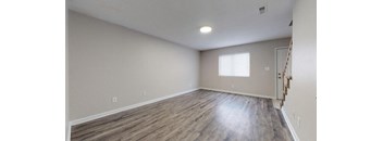 Living room with wood floors at the Colonial Village Apartments, Lincolnton, North Carolina. 