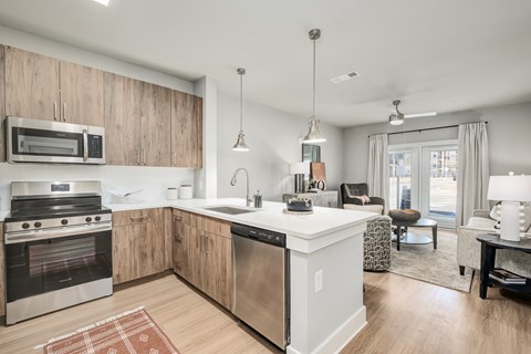 A modern kitchen with wooden cabinets and stainless steel appliances.