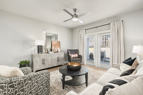 A living room with a black coffee table and a grey sofa.