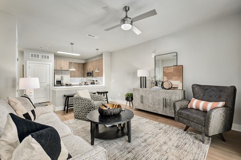 A modern living room with a grey sofa and a black coffee table.