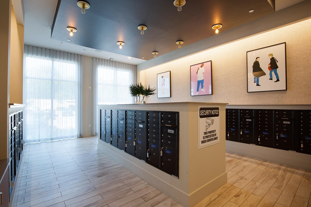 a view of the lobby of a building with many lockers at The Monroe Apartments, Austin, TX