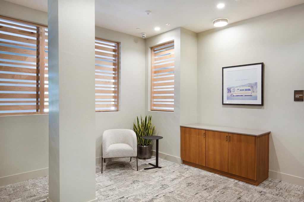 an office with a chair and a desk and windows at The Monroe Apartments, Austin, TX, 78741