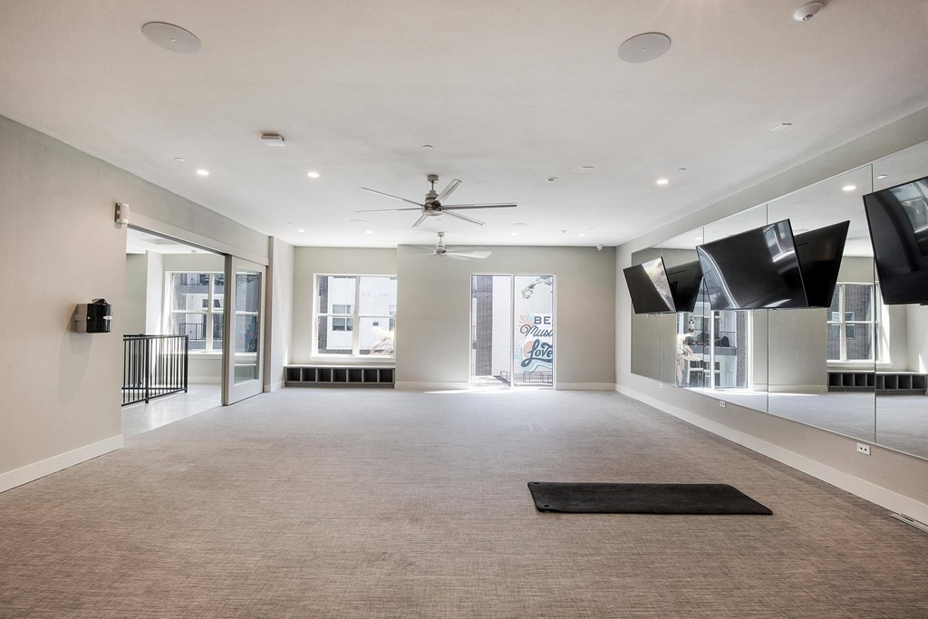 a large living room with a ceiling fan and a carpet at The Monroe Apartments, Texas, 78741