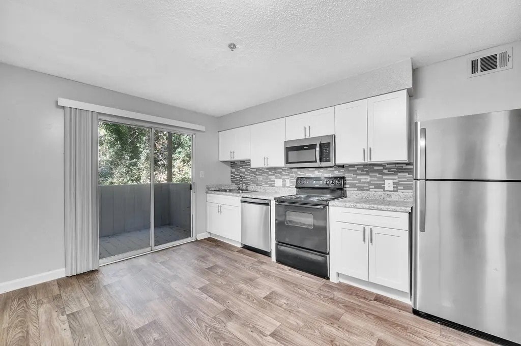 A Kitchen With Stainless Steel Appliances at Avondale Place Apartments, Avondale Estates, Georgia