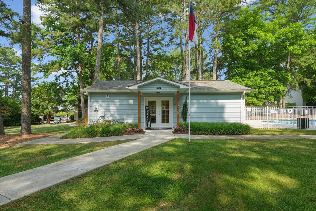 The Groves Leasing office with a flag on the front lawn.