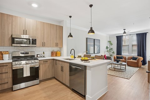 A modern kitchen with wooden cabinets and stainless steel appliances at Union Eleven Apartments, Georgia 30324