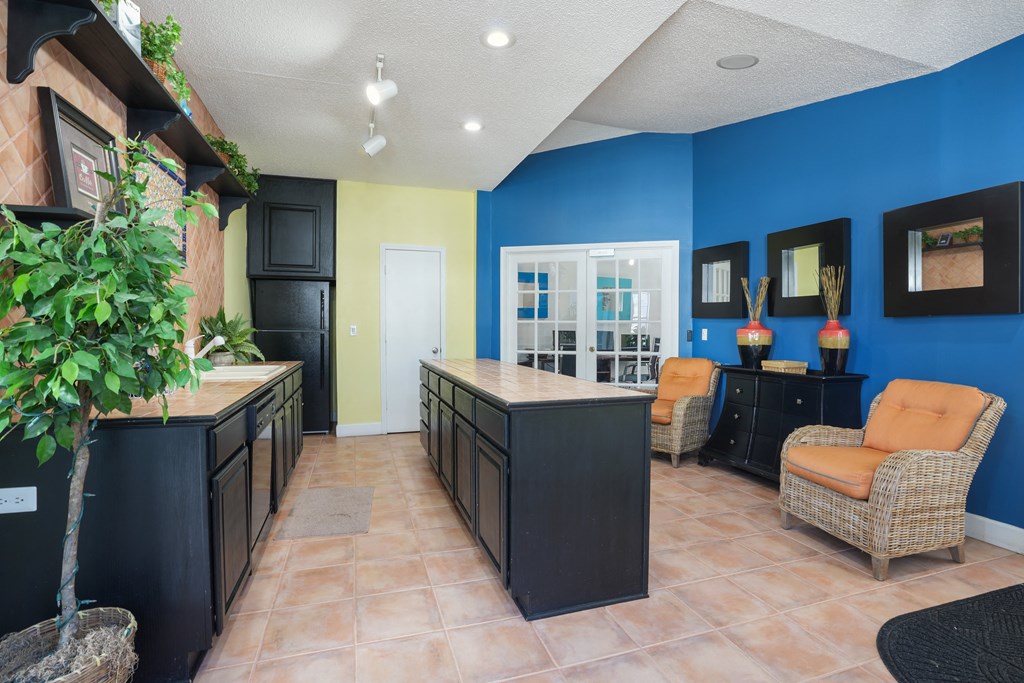 Lobby with a blue wall and orange chairs  at Cape Landing, Myrtle Beach, 29588