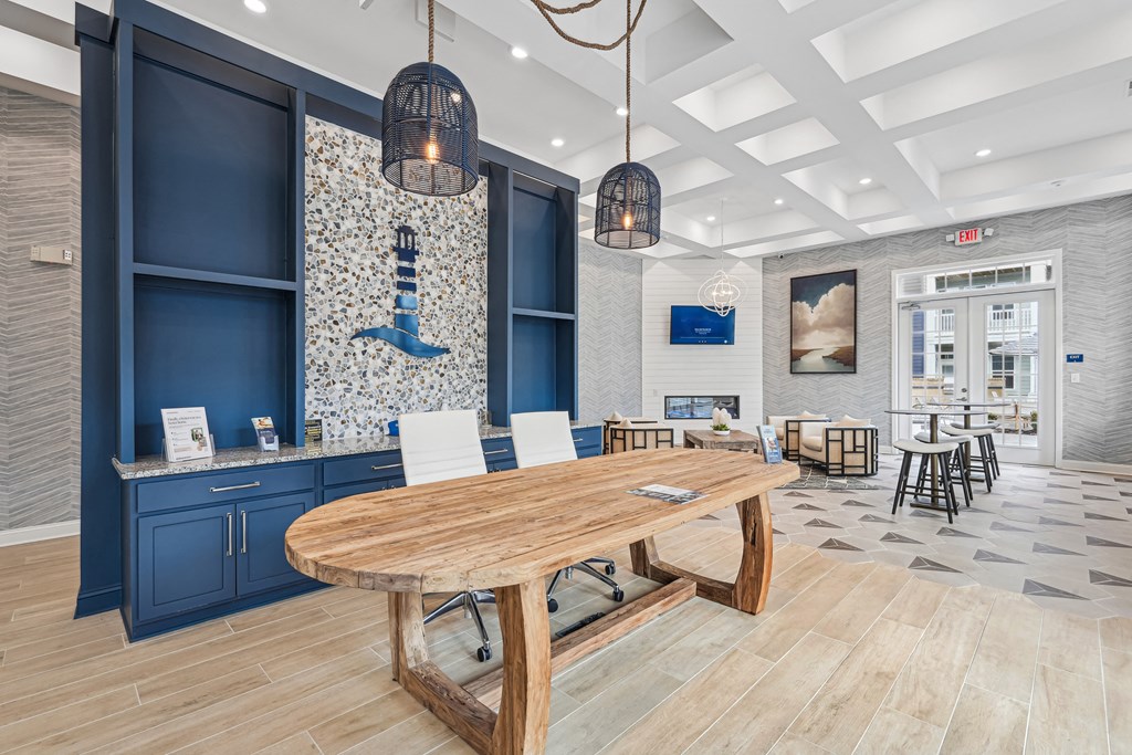 A modern dining area with a wooden table and chairs.at The Parker Leland, North Carolina  