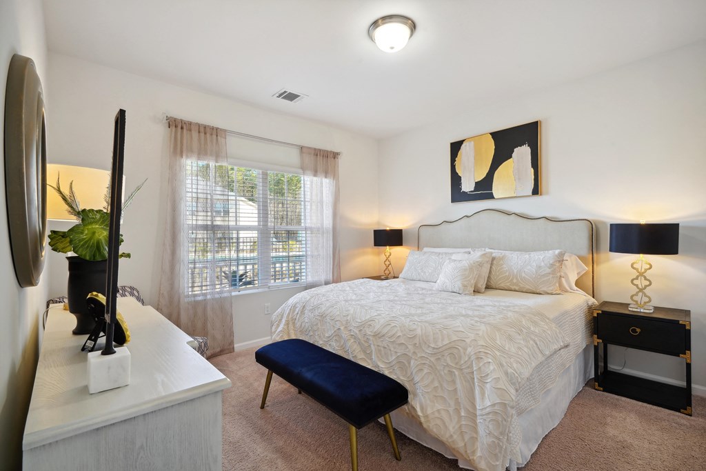 Bedroom with a bed and a dresser and a window  at The Meadows, Bloomingdale, GA, 31302
