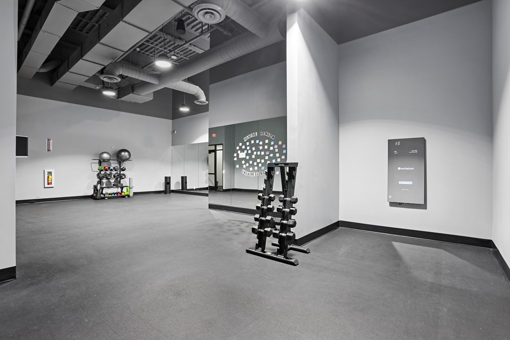 A room with a sculpture and a wall hanging.