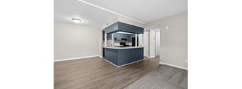 A kitchen area with a bar counter and cabinets.