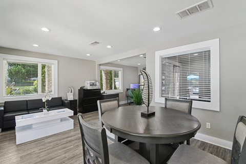 A modern dining room with a round table and chairs.