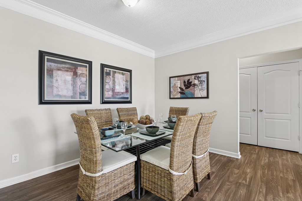 A dining room with a glass table and chairs.