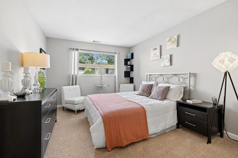 Bedroom with modern furniture and natural light at The Palms Apartments, South Carolina