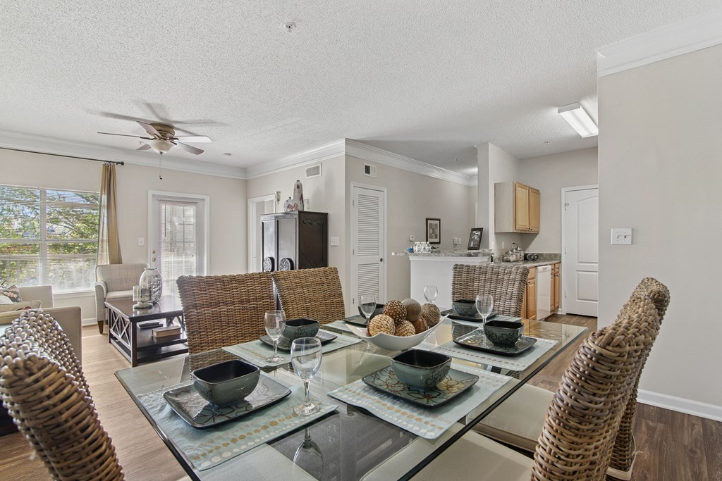A dining room with a glass table and chairs.