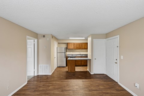 A kitchen with white cabinets and a wooden island.